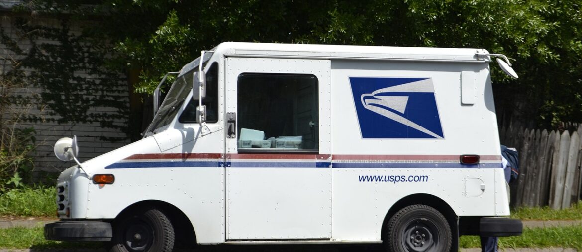 United States Postal Service mail truck parked on the side of the road.