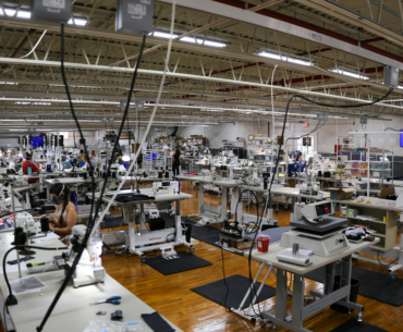 Kitsbow Apparel production facility floor with sewing machines.